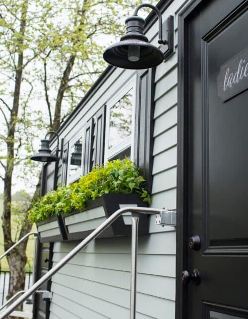 The Estate exterior — luxury restroom trailer with window boxes